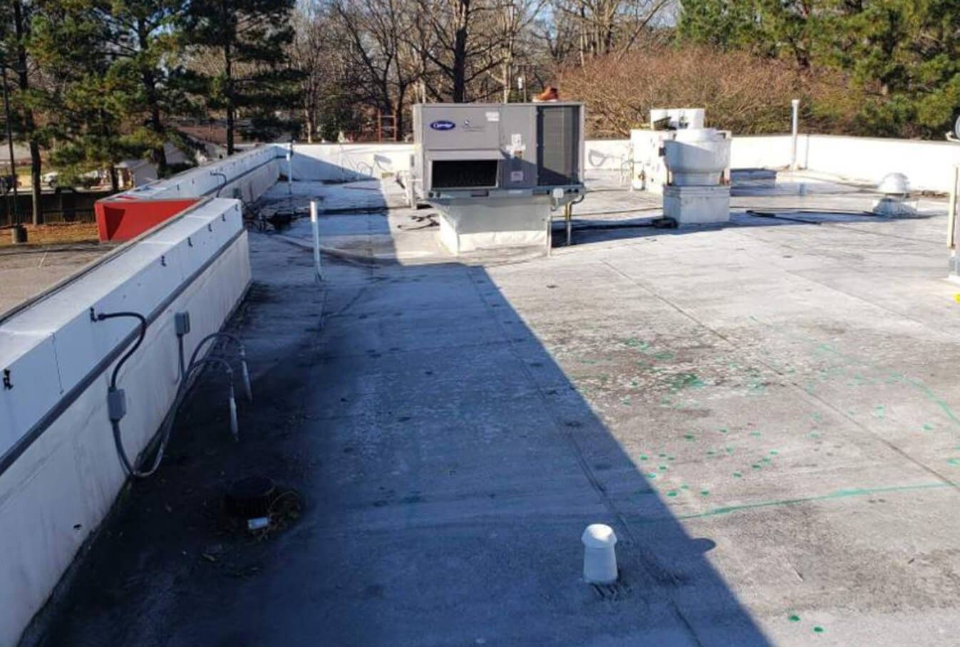 A weathered commercial roof surface before coating