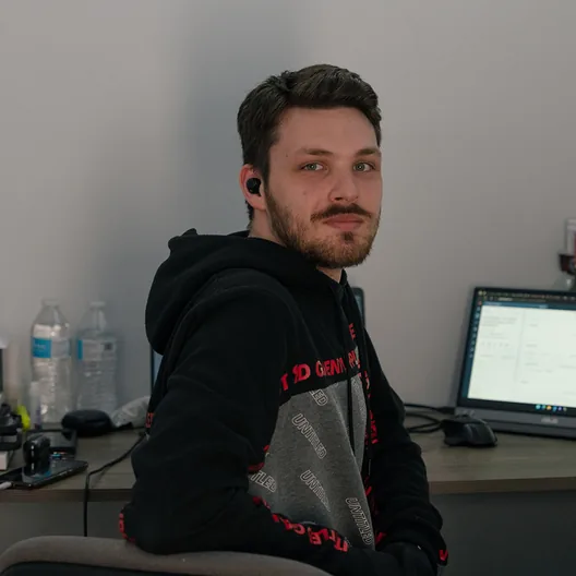 A RoofingSource office teammate turning from his desk