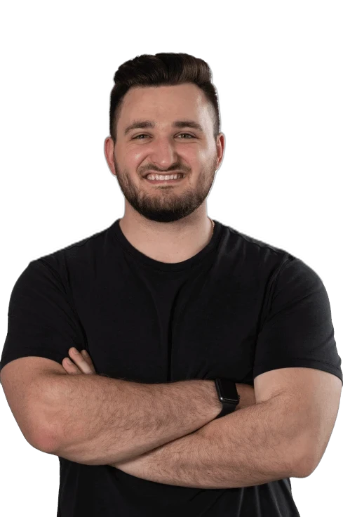 A smiling RoofingSource teammate in a black T-shirt, arms folded