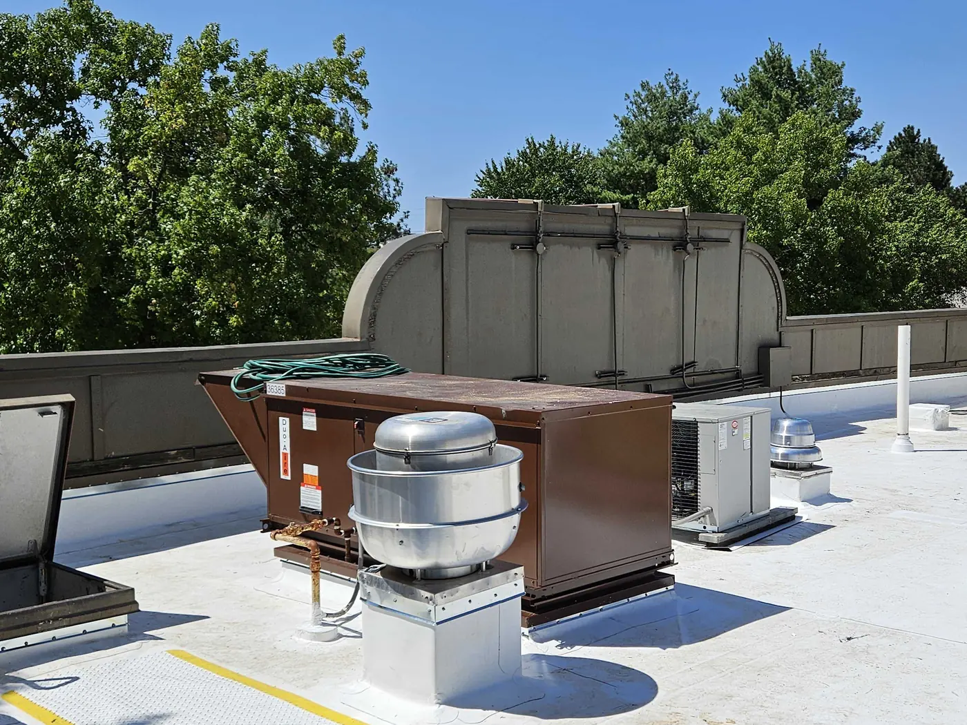 A commercial roof under a new white membrane, rooftop equipment set on top of it