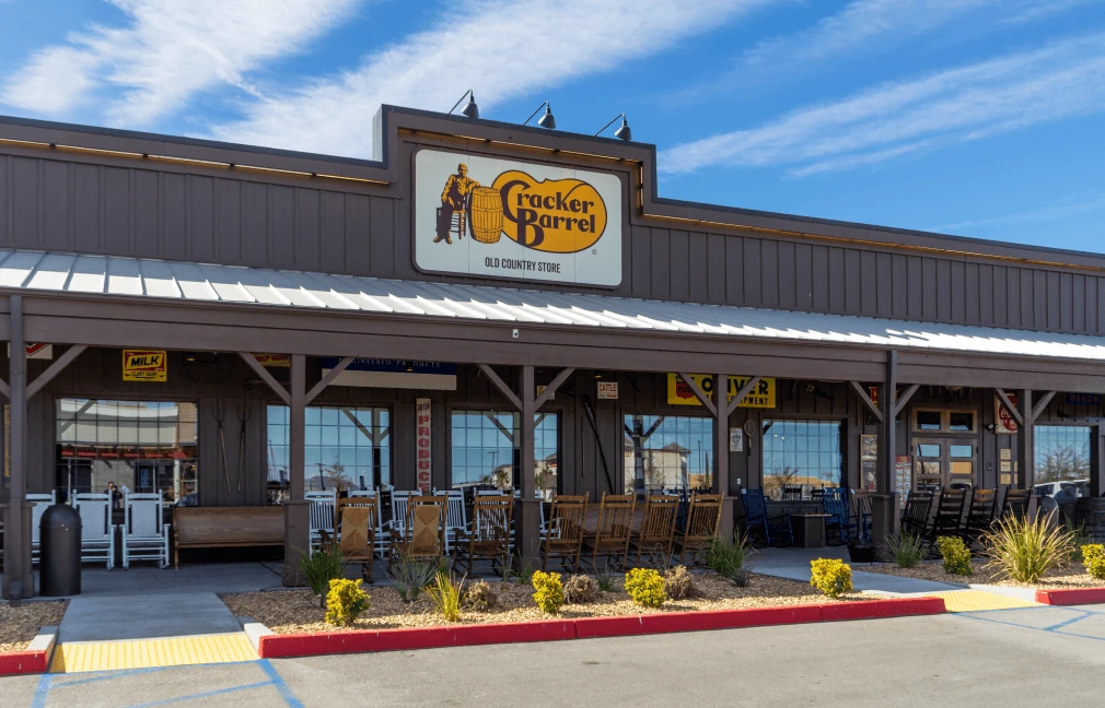 A Cracker Barrel restaurant, rocking chairs lined up along its covered porch.