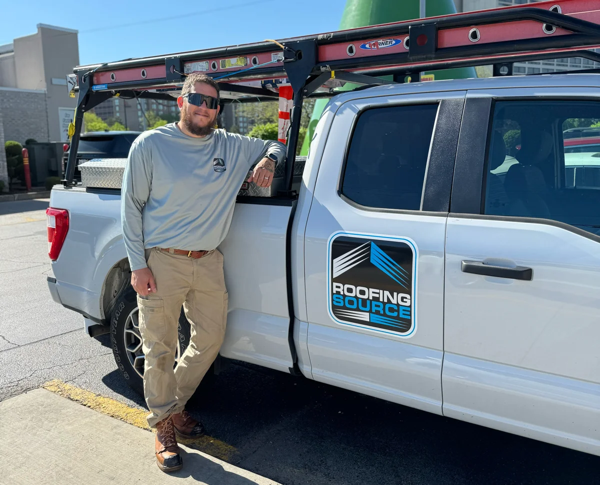 A Field Advisor beside his RoofingSource truck