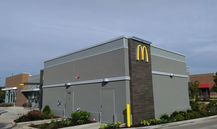 A rebuilt restaurant roof corner, finished, the golden arches sign on the wall
