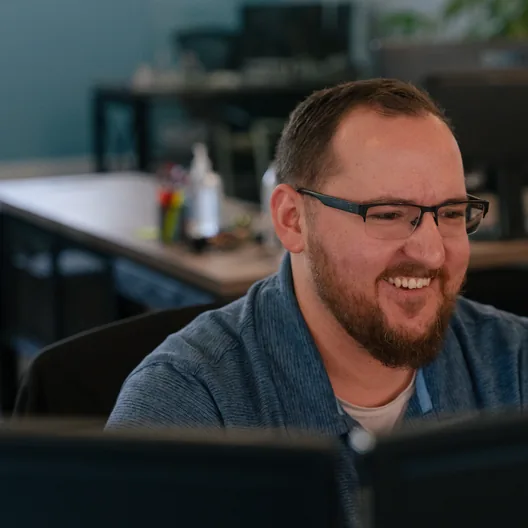 A RoofingSource office teammate at his desk