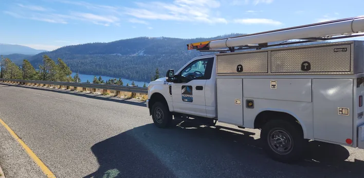 A RoofingSource service truck on a mountain road above Donner Lake